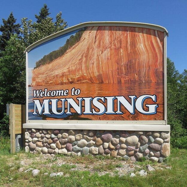 A Welcome to Munising sign you'll see when you visit Munising! 